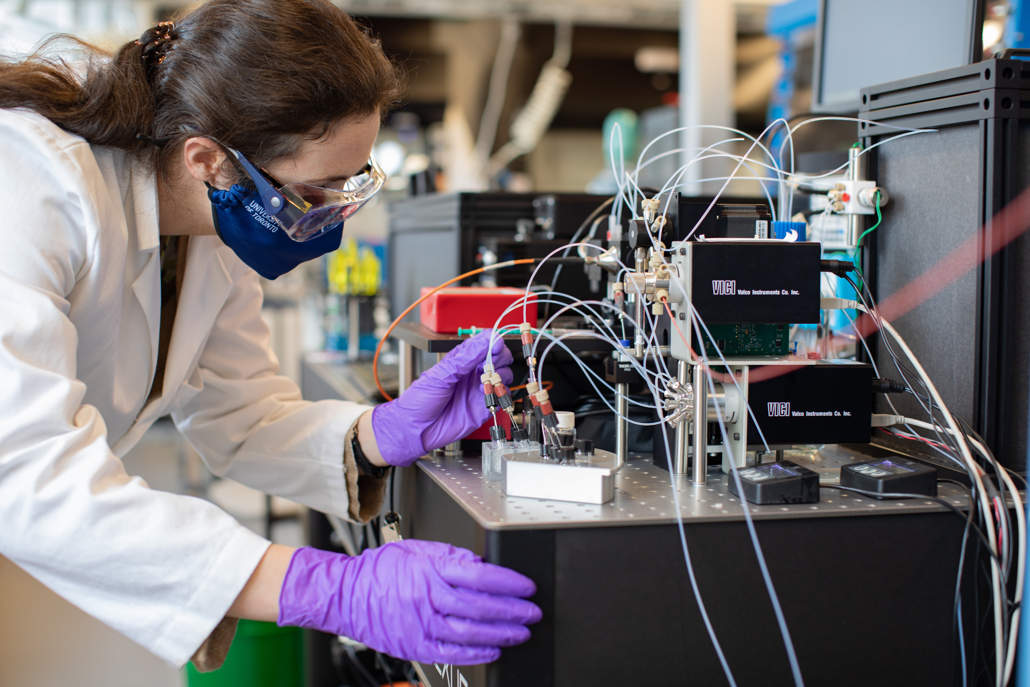 A woman working with equipment for artificial intelligence in a lab setting.