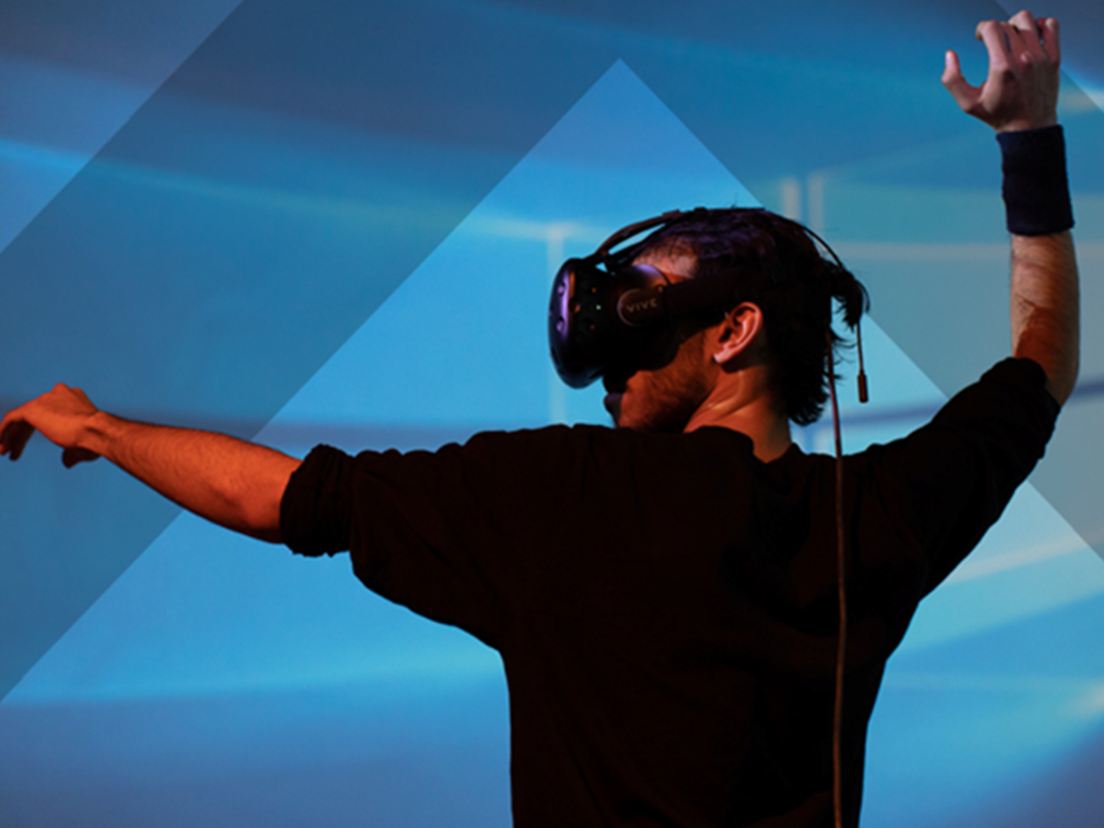 Man wearing virtual reality goggles interacting with his environment.