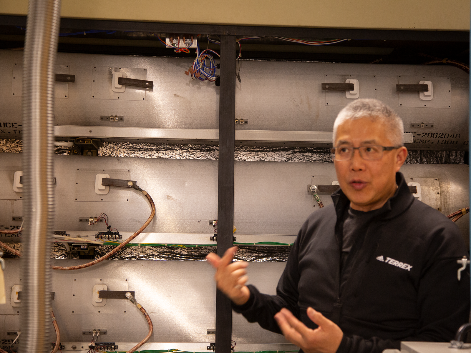 A man giving a presentation in front of Nanofabrication Centre