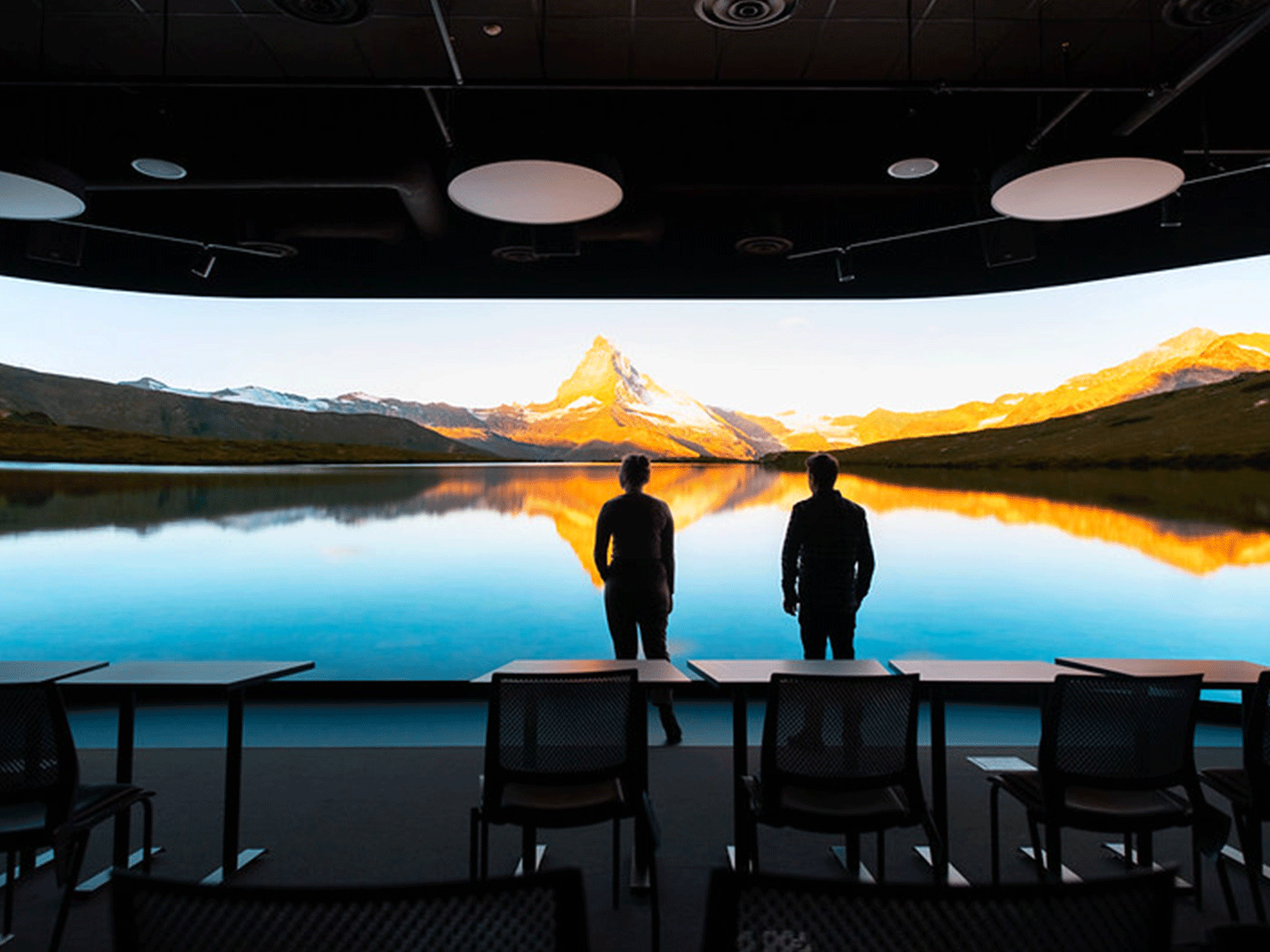 Image showing two people looking at a video wall.